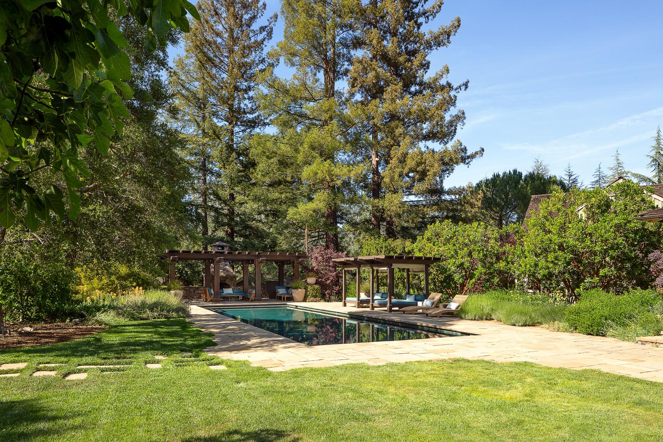 Luxurious Backyard with Swimming Pool and Lush Greenery in Woodside, CA
