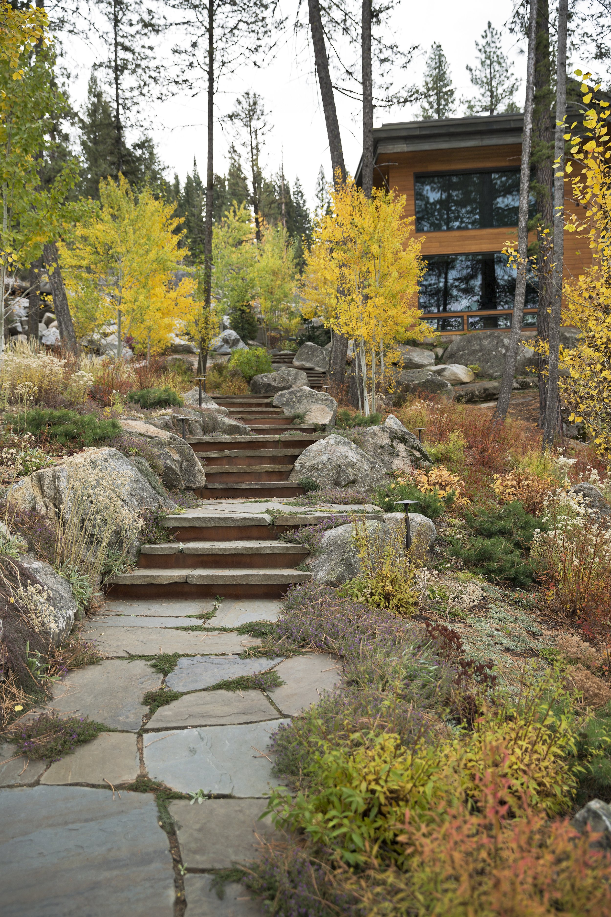 Stone Path Leading to a Modern McCall, Idaho Home Surrounded by Autumn Foliage