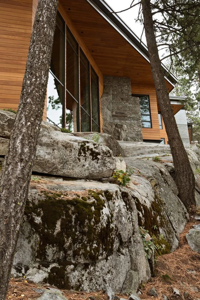Exterior View of a Modern McCall, Idaho Home Built into a Rocky Landscape with Large Windows