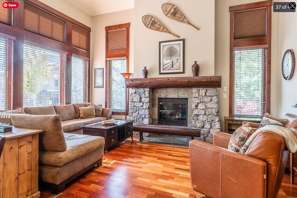 Juniper Crest Remodel - Before Living Room with Stone Fireplace and Large Windows