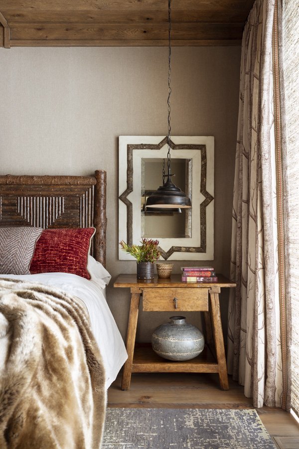 Rustic Bedroom with Wooden Nightstand and Decorative Mirror in Mammoth Lakes, CA