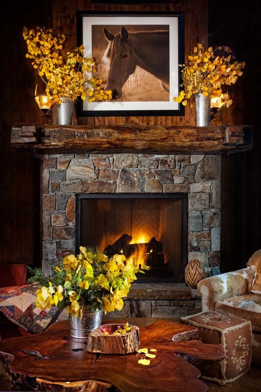 Rustic Living Room with Wooden Beams and Stone Fireplace in Mammoth Lakes, CA