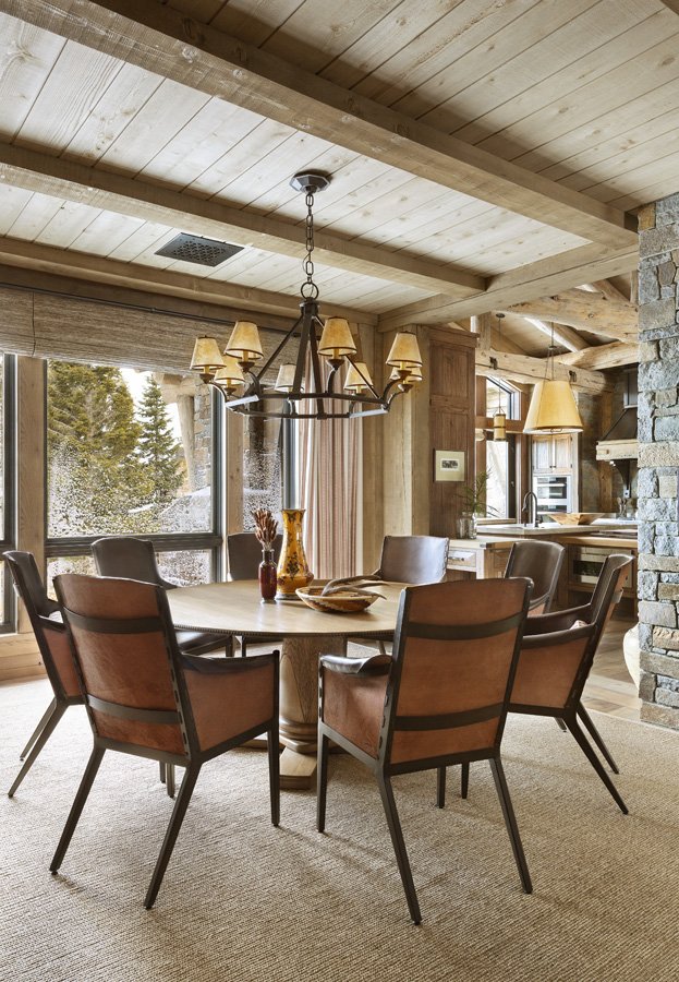 Rustic Dining Space with Elegant Chandelier by Brown Design Group in Mammoth Lakes, CA