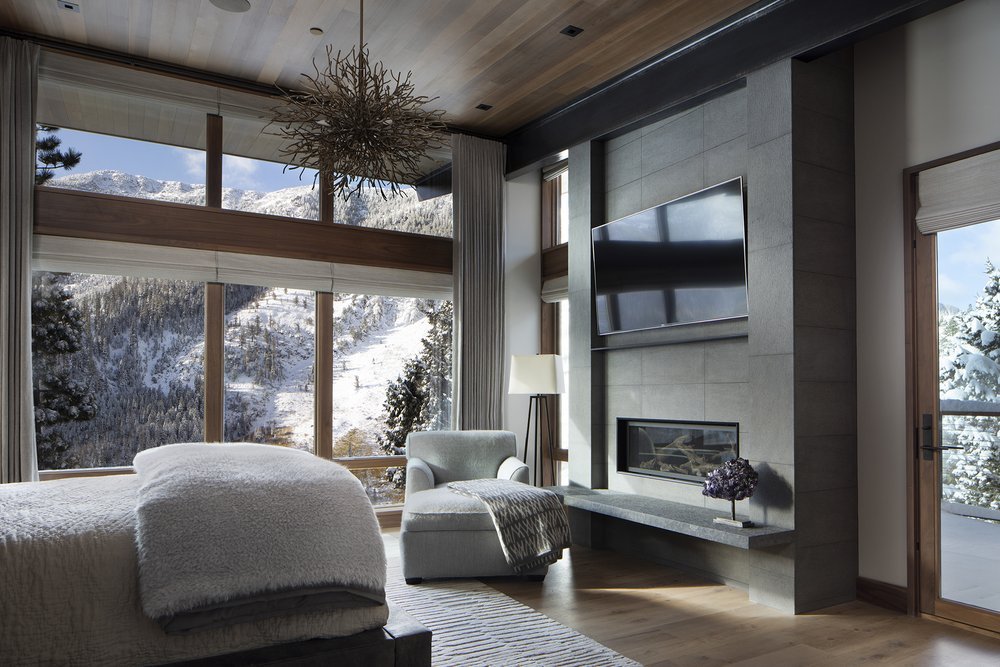 Modern Mountain Bedroom with Large Windows and Fur Bedding in Mammoth Lakes, CA
