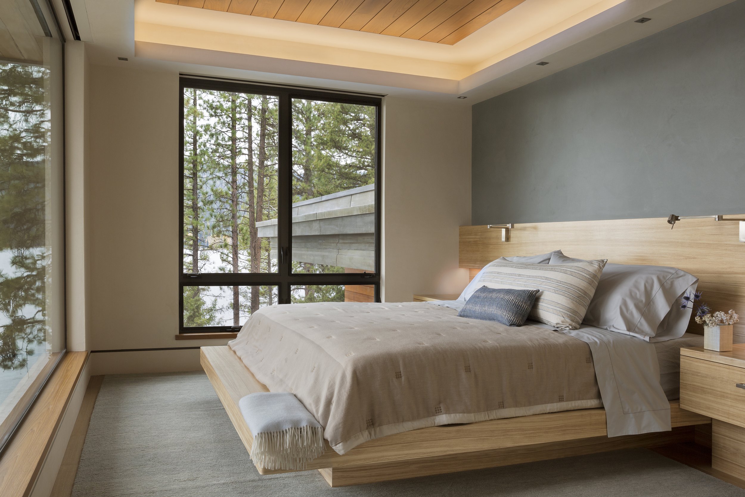 Modern Bedroom with Large Windows and Neutral Bedding in McCall, Idaho Home